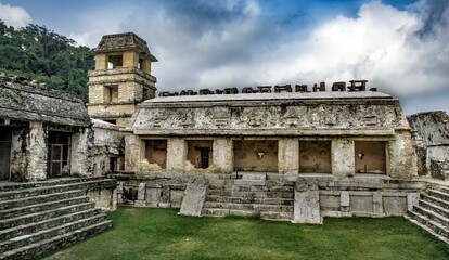 Scenic view of Palenque ruins and pyramids under blue cloudy sky in Mexico