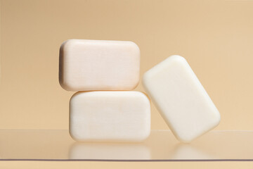 Pieces of plain natural soap on a beige isolated background. Image for your design