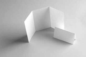 White mock up paper brochures on gray background.