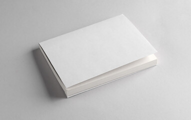 Book or notepad mockup with white cover on gray background. Template for design