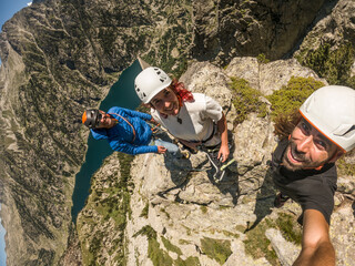 self portrait of friends in the middle of the mountain climbing in cavallers, lake, forest, mountain