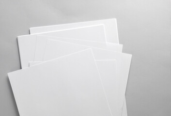 White blank sheets of a4 paper size or documents mockup on gray background. Template for design