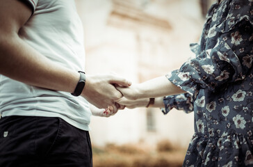 Close-up of a young loving couple holding hands. Romantic concept