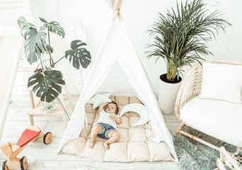 Little baby girl sleeping in a wigwam at home