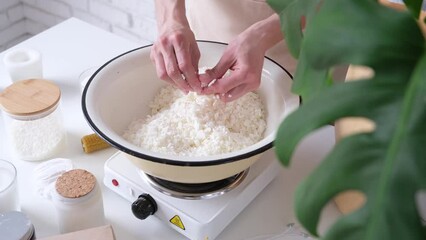 Creative occupation of candle making. woman making candles from soy wax, working in her creative space. mixing soy wax flakes
