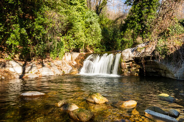 Water flowing over rocks in waterfall cascade in a forest. Silky water effect.