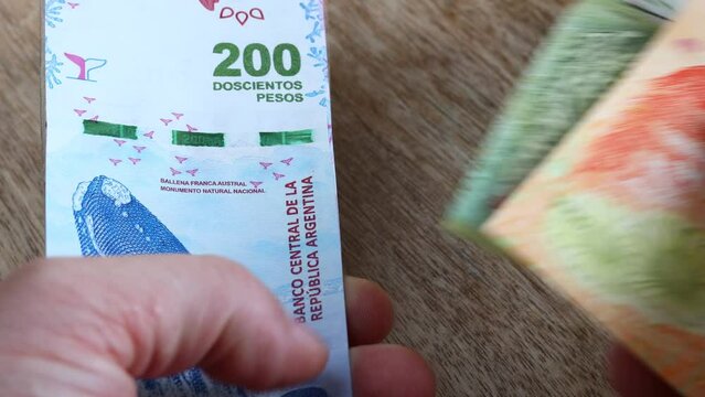 Argentina couting money, Argentine pesos, various money, Economic and financial concept