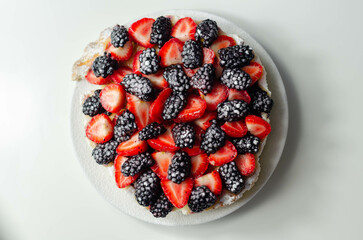 Butter enriched shortcrust pastry topped strawberries and blackberries, seasonal cake with colorful...