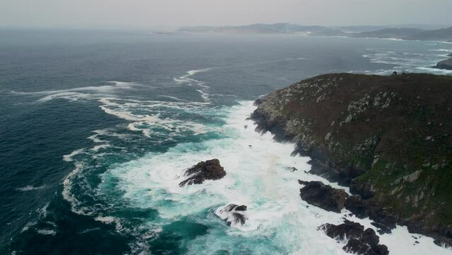 Foamy Tidal Waves Crashes Over Outcrops And Rocky Cliffs Near Caion Beach In Coruna, Spain. Aerial Wide Shot