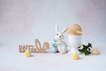 Easter bunny and egg in a stand on a light background