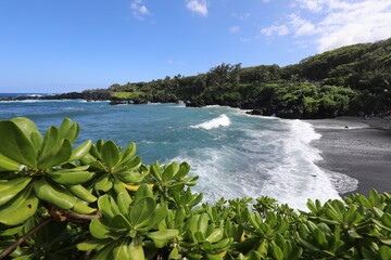 waves crashing on black sand beach