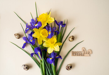 Beautiful floral arrangement of yellow and blue flowers with Easter eggs and the inscription of Happy Easter