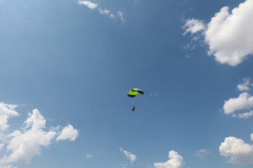 Summer sky. A parachute is in the cloudy sky.