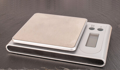 Kitchen scales on slate stone, macro.