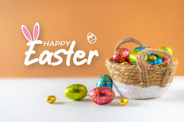 Fototapeta na wymiar Happy Easter text on orange background with decorated easter eggs in wicker basket on white table. Spring decorated set for egg hunt tradition. Banner for web with cream background