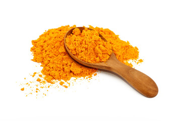 Wooden scoop spoon full of yellow turmeric powder
