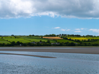 White cumulus clouds in the sky over the hilly Irish countryside. Green hills on a nice summer day....