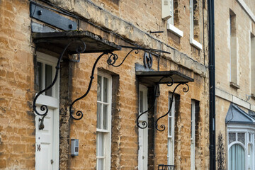 Woodstock, Oxfordshire,UK, 22_03_2023- A view along the high street towards Blenheim Palace with a mixture of historic building fronts and old doorways.