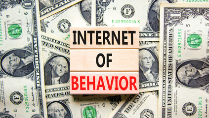 Internet of behavior symbol. Concept words Internet of behavior on wooden block on a beautiful background from dollar bills. Dollar bills. Business Internet of behavior concept. Copy space.