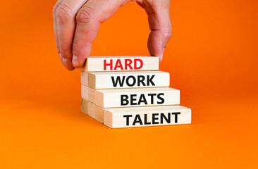 Hard work beats talent symbol. Concept words Hard work beats talent on wooden block. Beautiful orange table orange background. Motivational business hard work beats talent concept. Copy space.