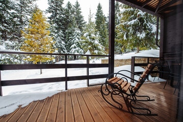 Armchair on the terrace of the Alpine Chalet house in the mountains