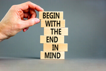 Begin in end of mind symbol. Concept words Begin with the end in mind on wooden blocks. Beautiful grey table grey background. Businessman hand. Business begin in end of mind concept. Copy space. - obrazy, fototapety, plakaty
