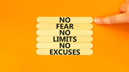No fear limits excuses symbol. Concept words No fear no limits no excuses on wooden stick. Beautiful orange background. Businessman hand. Business not fear limits excuses concept. Copy space.