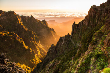 Beautiful sunrise in Madeira highest mountains range. Hiking trial from Pico do Areerio to Pico do Ruivo. Madeira, Portugal