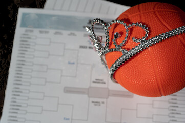 Basketball, tiara, and blank bracket signifying a Cinderella season.