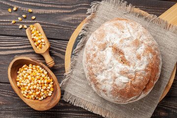 Fresh cornbread and corn grains on the table. Food grain crisis concept. Top view