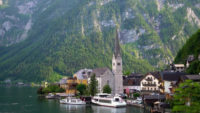 Footage of Hallstatt village, Alps mountains background in Austria Stock drone video