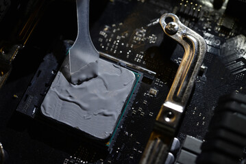Applying thermal paste to the surface of the computer processor. Thermal interface on the processor.