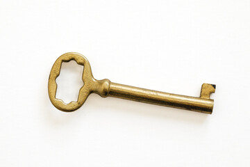 vintage brass key on white background
