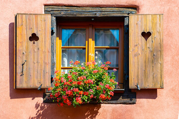 Old window and flowers on the Vintage house, Eguisheim, France