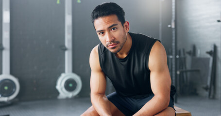 Gym, sports man and fitness training by man serious about health, wellness and competitive mindset. Face, portrait and asian instructor sitting before workout, exercise and cardio exercises in Japan - Powered by Adobe