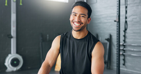 Fitness, exercise and laughing with a man in a gym for a workout or training to get strong or healthy. Wellness, smile and portrait with a happy young male athlete in a health club for exercising