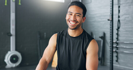 Fitness, exercise and laughing with a man in a gym for a workout or training to get strong or healthy. Wellness, smile and portrait with a happy young male athlete in a health club for exercising - Powered by Adobe