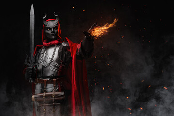 Art of esoteric wizard dressed in silver cuirass and red robe casting fireball.