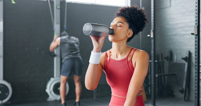 Black Woman, Rest And Drinking Water With Bottle For Fitness, Wellness And Health In Gym. Young Female, Athlete Or Healthy Lady Relax, Being Thirsty After Practice Or Training For Exercise Or Workout