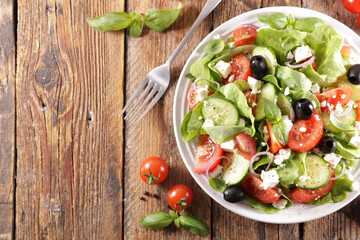 vegetable salad with lettuce, tomato, feta cheese and olive