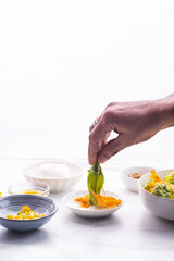 The chef prepares a Mediterranean recipe  Blossoms flowers zucchini (Courgette, Squash Flowers) or Fiori di zucca and ingredients for frying with mozzarella or others cheese and salted anchovy