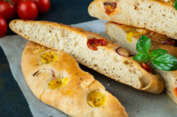 Homemade Italian Focaccia with basil and tomatoes. Italian food. Italian bread