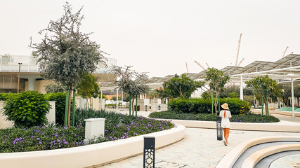 UAE, Abu Dhabi - 13th march, 2023: tourist visit walk in Masdar city central park . Worlds most...