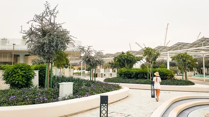 Fotobehang UAE, Abu Dhabi - 13th march, 2023: tourist visit walk in Masdar city central park . Worlds most sustainable communities park infrastructure. Urban low-carbon development project © Evaldas