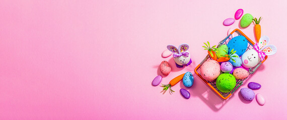 Obraz na płótnie Canvas Easter sale concept. Shopping basket with festive symbols - rabbit, eggs, bird, traditional decor