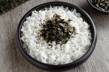 Rice with vegan furikake seasoning with torn nori seaweed on a top.