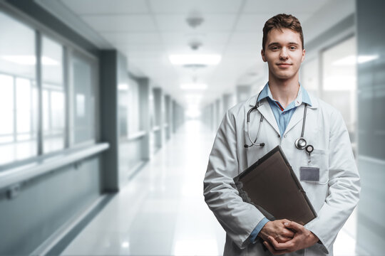 Portrait of professional male doctor with white robe in modern hospital.