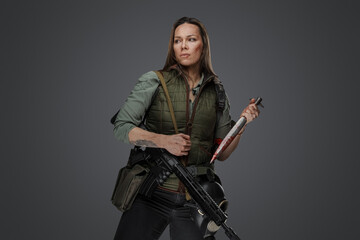 Fototapeta na wymiar Shot of Mercenary woman in setting of post apocalypse looking to side.