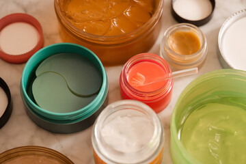 Skin health care products with lip balm with eye patches and snail mucin gel close up. Morning...