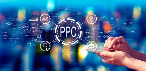 PPC - Pay per click concept with person using a smartphone in a city at night